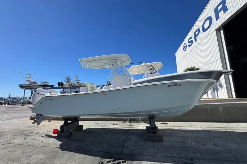 Slide: The Image of 2022 Front Runner 26 Center Console boat displayed outdoors near a large building. - 2