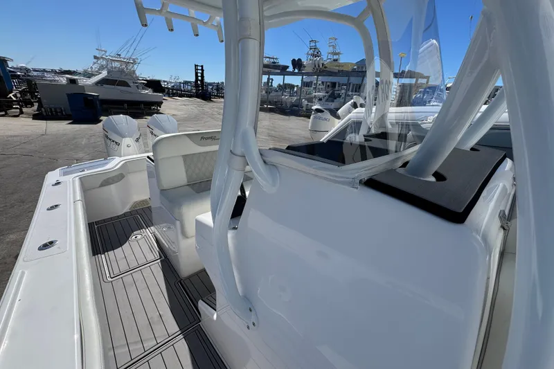 Slide: The Image of 2022 Front Runner 26 Center Console boat docked, showcasing interior seating and dual engines. - 24