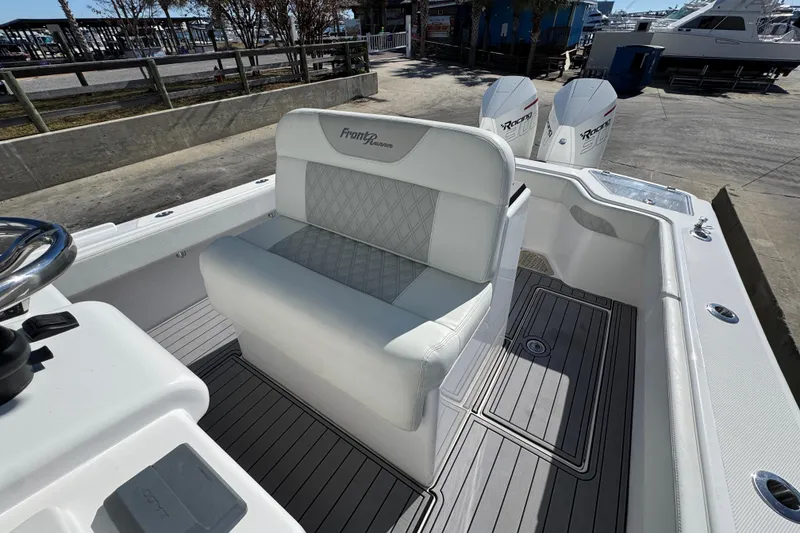 Slide: The Image of 2022 Front Runner 26 Center Console boat interior with seating and dual engines. - 25