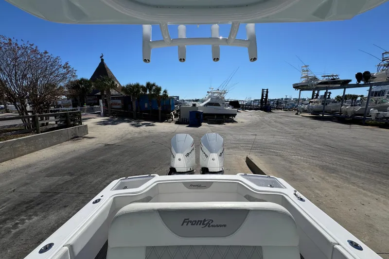 Slide: The Image of 2022 Front Runner 26 Center Console boat at marina with clear blue sky. - 27