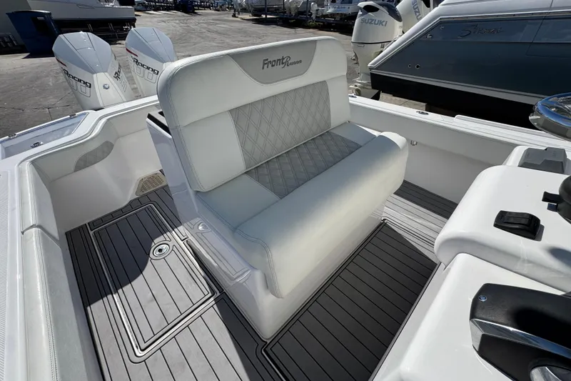 Slide: The Image of 2022 Front Runner 26 Center Console boat interior with white seating and dual engines. - 32