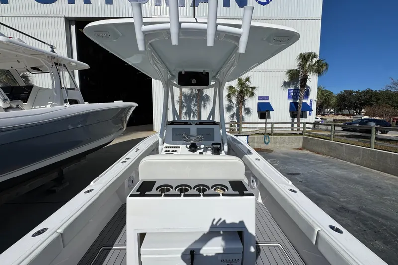 Slide: The Image of 2022 Front Runner 26 Center Console boat in marina, showcasing helm and seating area. - 34