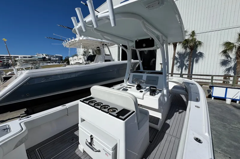 Slide: The Image of 2022 Front Runner 26 Center Console boat with modern helm and fishing rod holders. - 35
