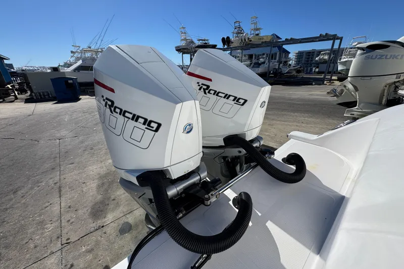 Slide: The Image of Twin outboard engines on a 2022 Front Runner 26 Center Console boat at a marina. - 39