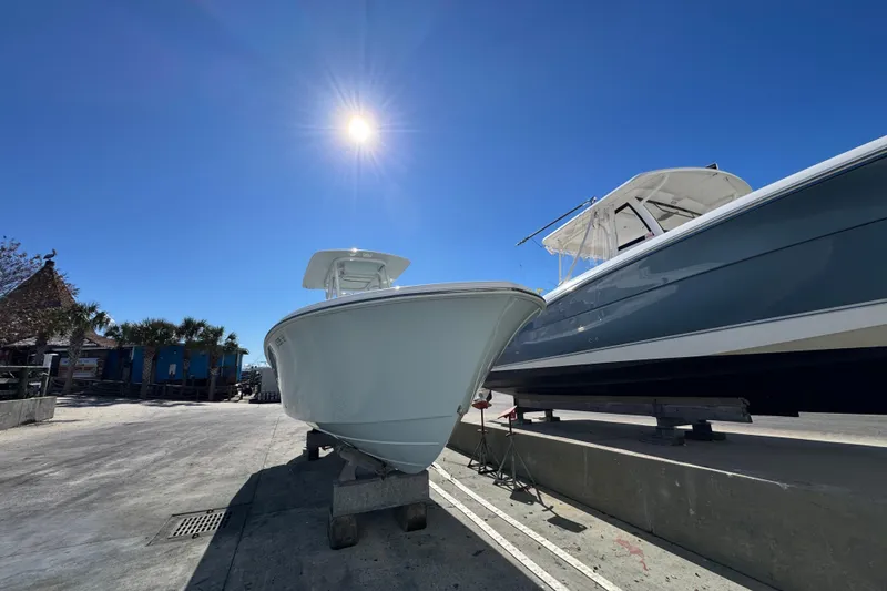 Slide: The Image of 2022 Front Runner 26 Center Console boat under bright sun on a dock. - 6