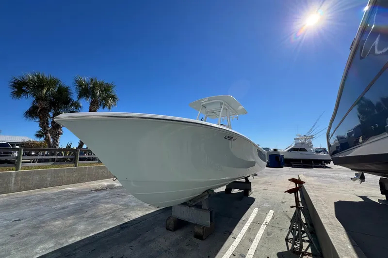 Slide: The Image of 2022 Front Runner 26 Center Console boat on display under clear blue sky. - 8