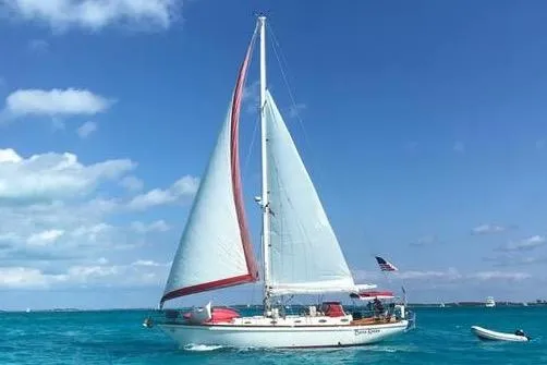 The Image of Sailboat "Creekmore Cutter" 1997 on clear blue ocean under sunny sky. - 0