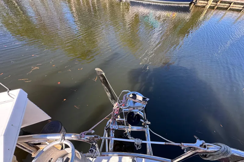 Slide: The Image of Bow of 1997 Creekmore Cutter sailboat on calm water, showing anchor and rigging. - 11