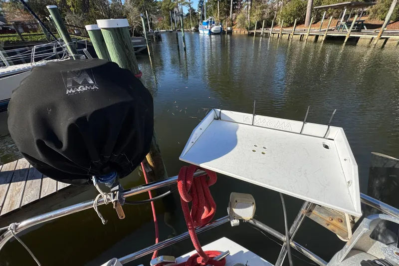 Slide: The Image of Creekmore Cutter 1997 boat with Magma grill cover and dock view. - 12