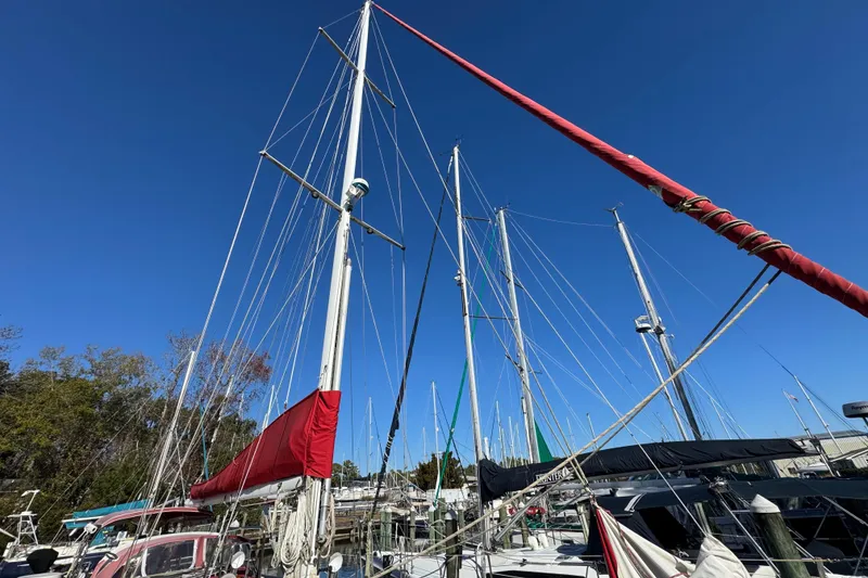 Slide: The Image of Sailboats docked under clear blue sky, featuring a 1997 Creekmore Cutter. - 20