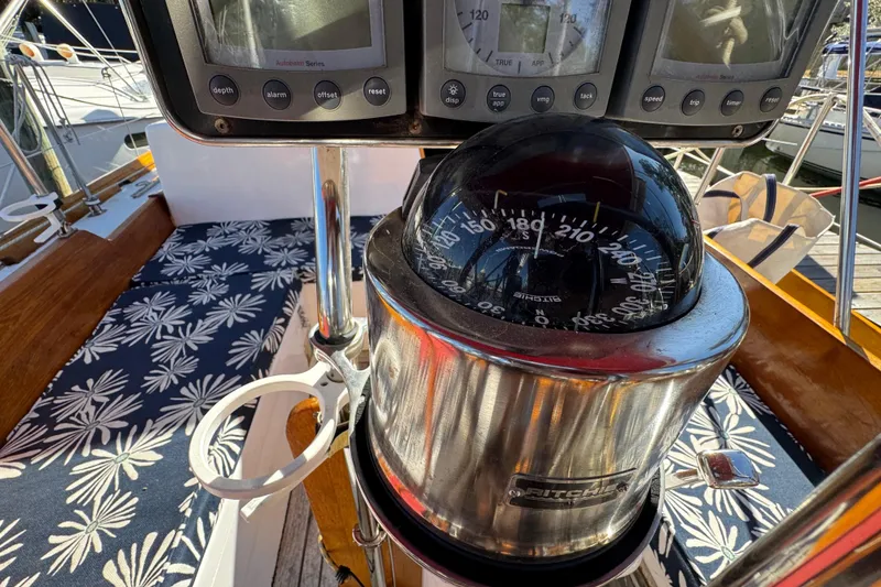 Slide: The Image of Compass and navigation instruments on a 1997 Creekmore Cutter sailboat deck. - 28