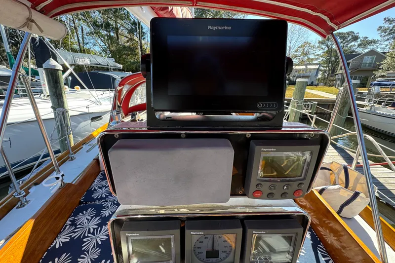 Slide: The Image of Cockpit of 1997 Creekmore Cutter with Raymarine navigation equipment at marina. - 29