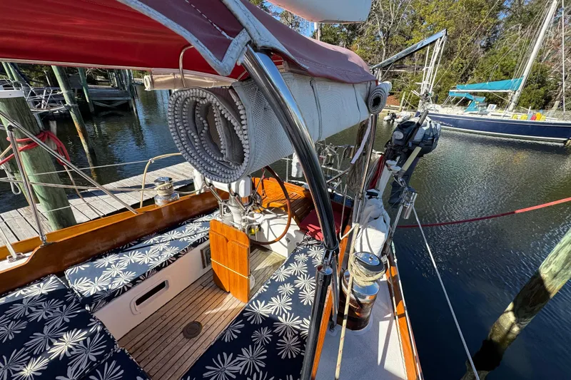Slide: The Image of Creekmore Cutter 1997 sailboat with floral cushions docked at marina. - 33
