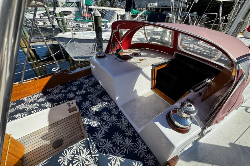 Slide: The Image of 1997 Creekmore Cutter sailboat cockpit with floral cushions and red canopy. - 38