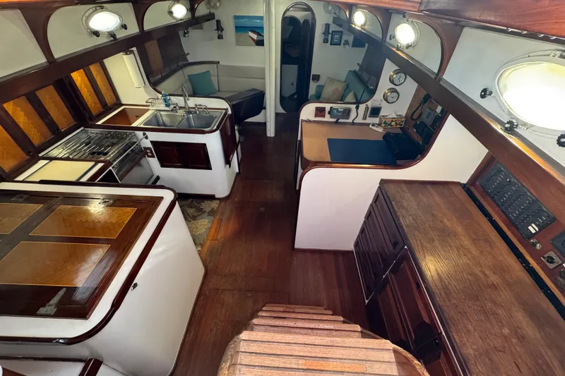 Slide: The Image of Interior of 1997 Creekmore Cutter sailboat with wooden cabinetry and compact kitchen area. - 41