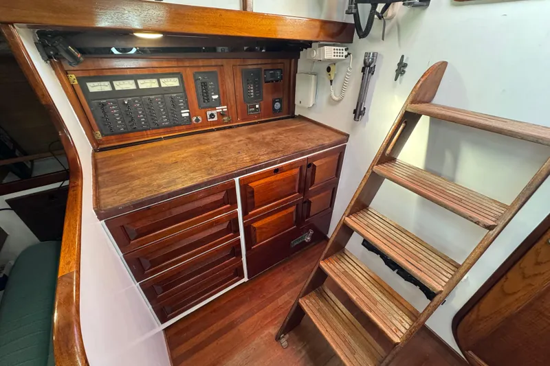 Slide: The Image of Interior of 1997 Creekmore Cutter sailboat with wooden cabinetry and control panel. - 45