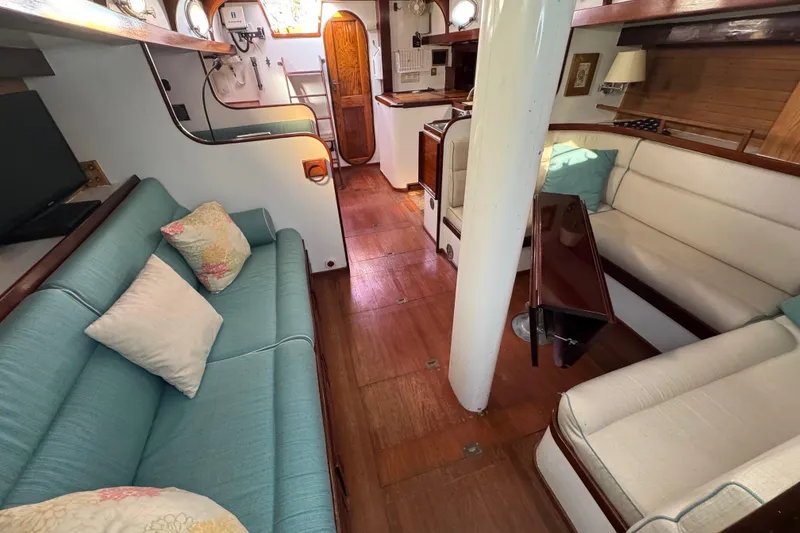 Slide: The Image of Interior of 1997 Creekmore Cutter sailboat with cozy seating and wooden flooring. - 49