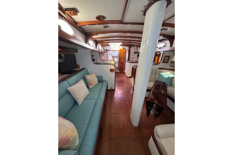 Slide: The Image of Interior of 1997 Creekmore Cutter sailboat with cozy seating and wooden accents. - 58