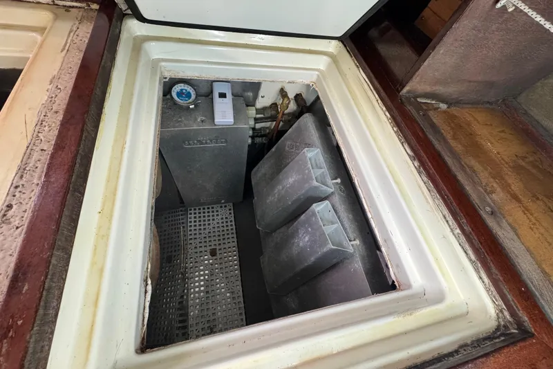 Slide: The Image of 1997 Creekmore Cutter engine compartment with metal components and gauge. - 66
