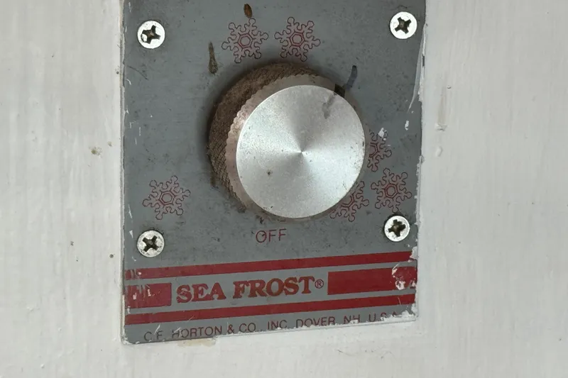 Slide: The Image of Sea Frost control knob on Creekmore Cutter 1997, featuring snowflake design and off setting. - 68