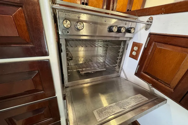 Slide: The Image of Stainless steel oven in 1997 Creekmore Cutter, surrounded by wooden cabinetry. - 70