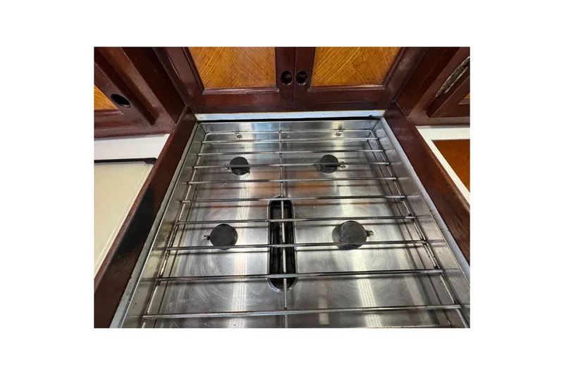 Slide: The Image of Stainless steel stove on 1997 Creekmore Cutter yacht with wooden cabinetry. - 71