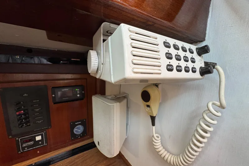Slide: The Image of 1997 Creekmore Cutter boat radio and control panel with microphone and speaker. - 75
