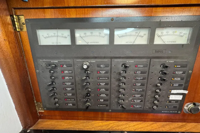 Slide: The Image of Electrical control panel on a 1997 Creekmore Cutter boat, featuring various switches and gauges. - 76