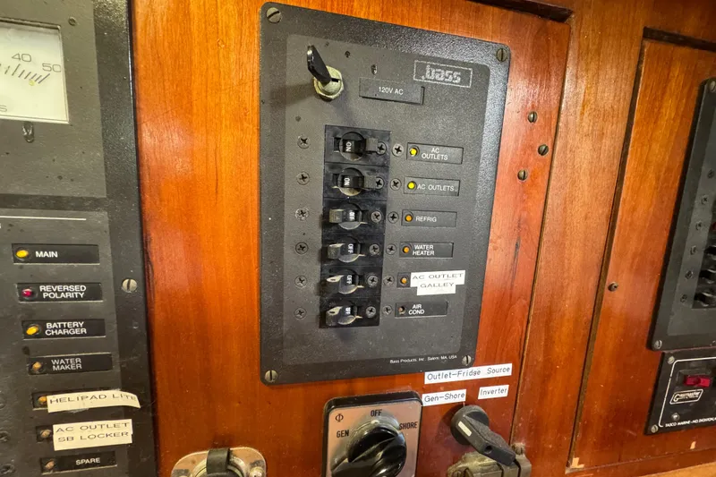 Slide: The Image of Electrical panel on 1997 Creekmore Cutter boat with labeled switches and controls. - 78