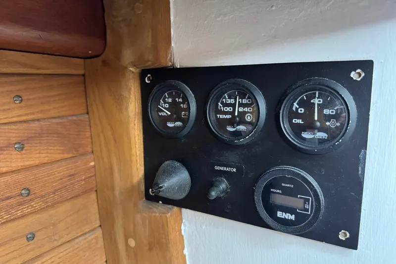 Slide: The Image of Instrument panel of a 1997 Creekmore Cutter sailboat with gauges and generator switch. - 81