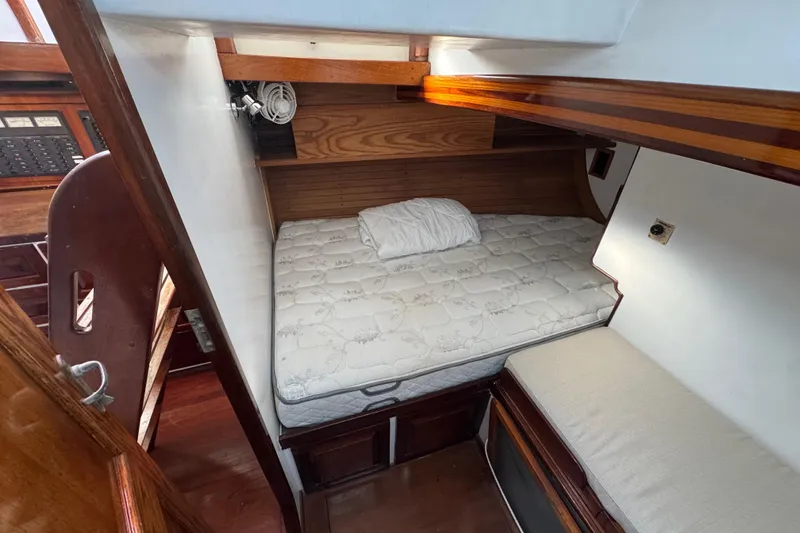 Slide: The Image of Cozy cabin interior of 1997 Creekmore Cutter sailboat with bed and wooden accents. - 85