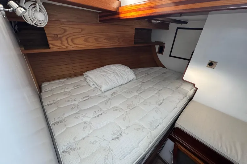Slide: The Image of Cozy cabin interior of 1997 Creekmore Cutter with wooden accents and comfortable bedding. - 86