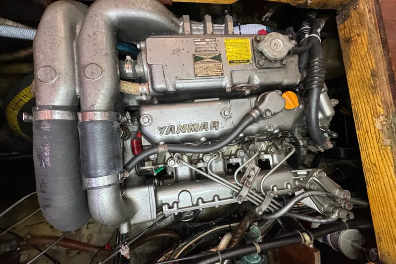 Slide: The Image of Engine of a 1997 Creekmore Cutter sailboat, featuring a Yanmar diesel engine. - 91