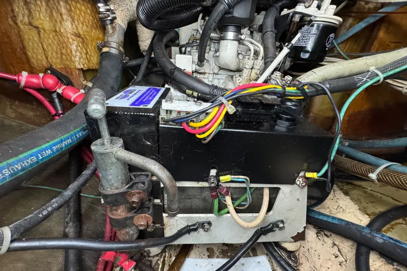 Slide: The Image of Engine compartment of a 1997 Creekmore Cutter with wiring and hoses visible. - 94