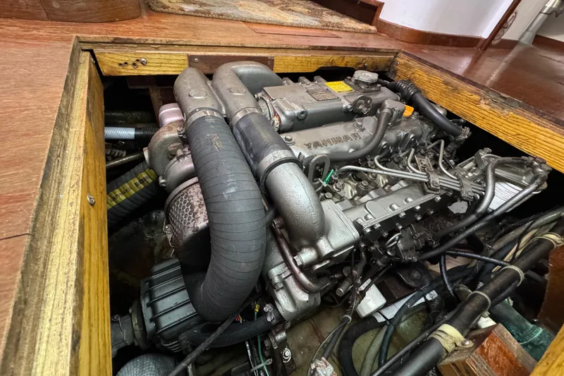 Slide: The Image of Engine compartment of a 1997 Creekmore Cutter sailboat, featuring a Yanmar engine. - 95