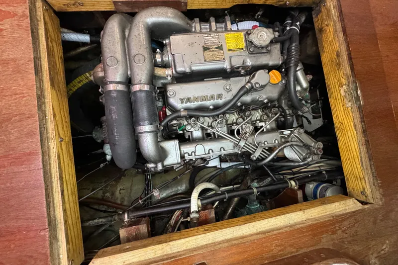 Slide: The Image of Engine compartment of a 1997 Creekmore Cutter sailboat, featuring a Yanmar engine. - 97