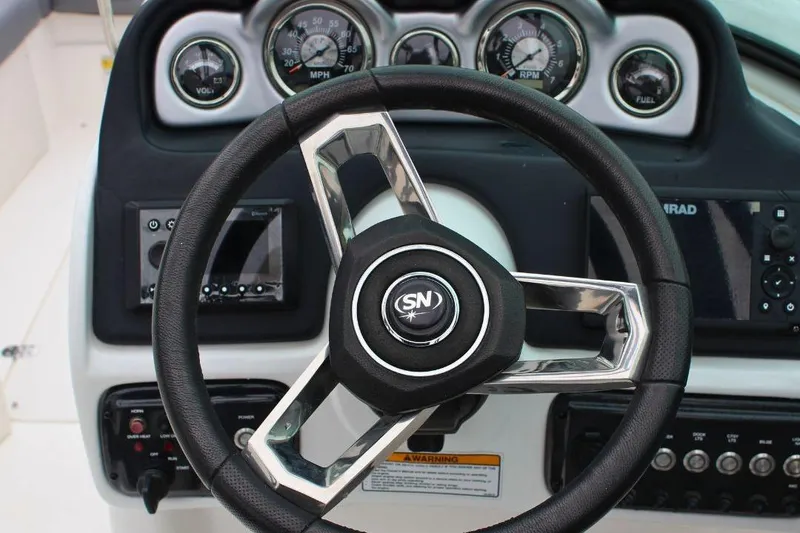 Slide: The Image of Steering wheel and dashboard of 2023 NauticStar 243 DC Deck boat. - 7