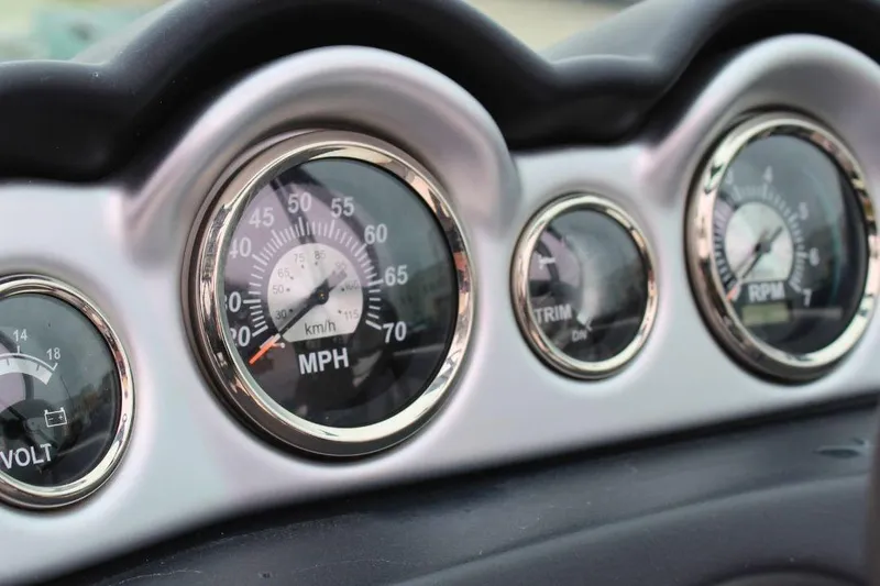 Slide: The Image of Dashboard gauges of 2023 NauticStar 243 DC Deck boat, showing speed, trim, and RPM. - 8