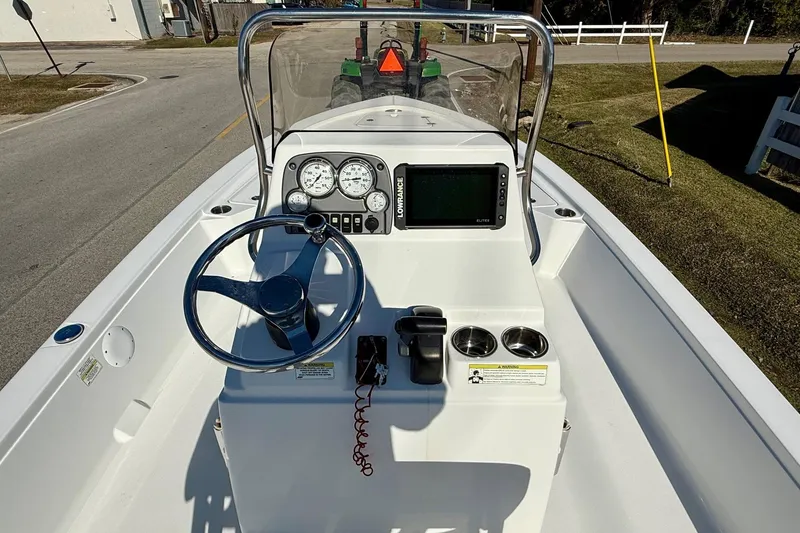 Slide: The Image of 2014 Sportsman Tournament 214 Bay Boat dashboard with steering wheel and navigation system. - 11