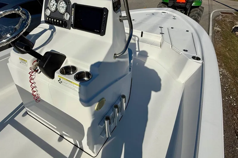 Slide: The Image of 2014 Sportsman Tournament 214 Bay Boat cockpit with steering wheel and control panel. - 14