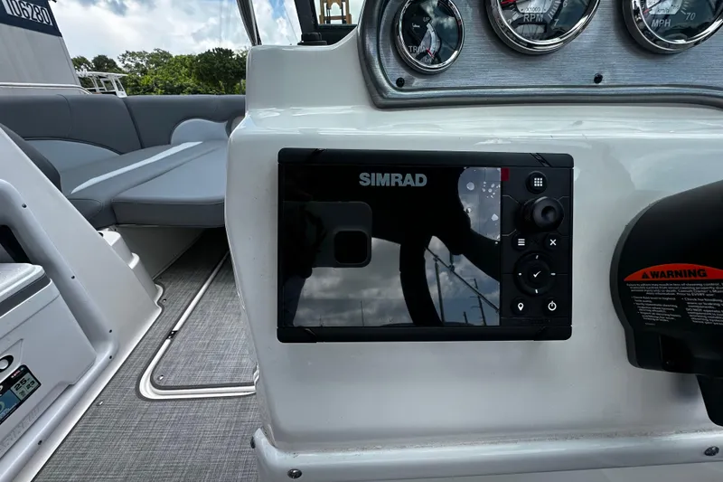 Slide: The Image of 2024 NauticStar 203 DC Deck boat dashboard with Simrad display and gauges. - 11