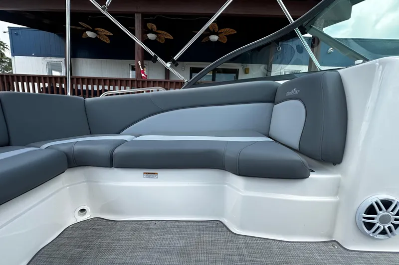 Slide: The Image of 2024 NauticStar 203 DC Deck boat interior with gray seating and modern design. - 13