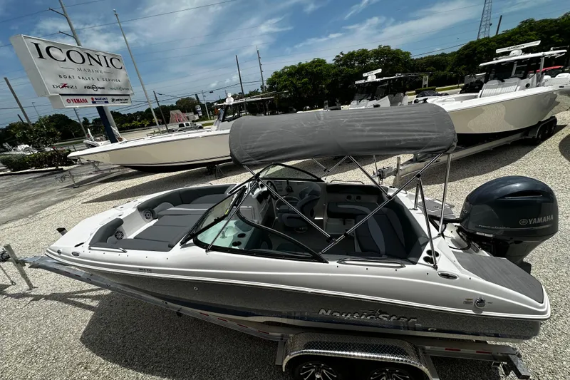 Slide: The Image of 2024 NauticStar 203 DC Deck boat with Yamaha engine at Iconic Marine dealership. - 5
