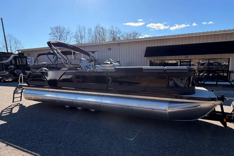 Slide: The Image of 2026 Veranda Relax VR 265 VL pontoon boat, sleek black design, parked outdoors. - 5