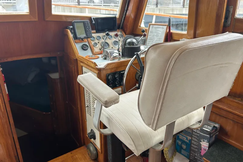 Slide: The Image of 1976 Bristol Trawler helm with navigation instruments and captain's chair. - 17