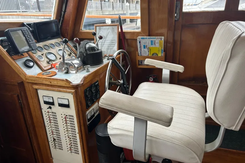 Slide: The Image of 1976 Bristol Trawler helm with navigation instruments and white captain's chair. - 18