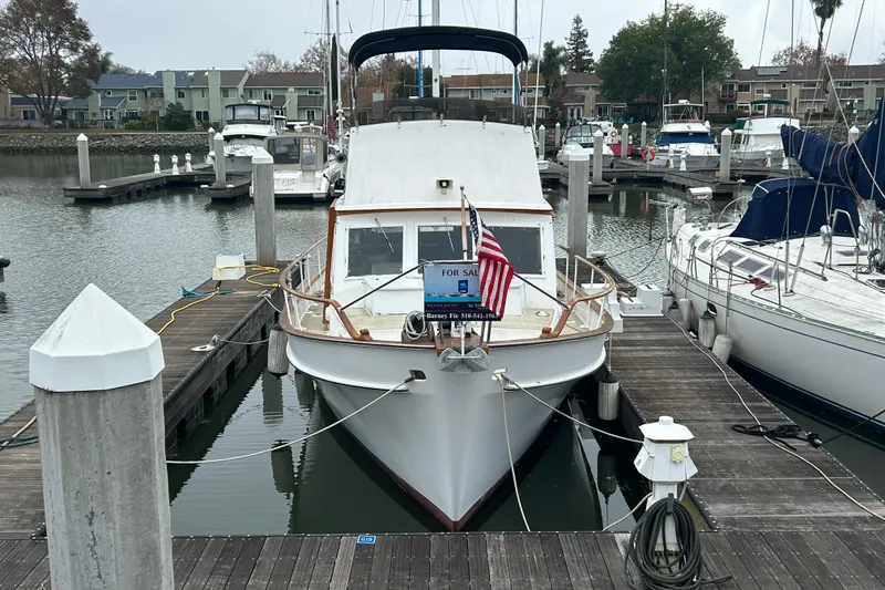 Slide: The Image of 1976 Bristol Trawler docked at marina, for sale sign displayed. - 2
