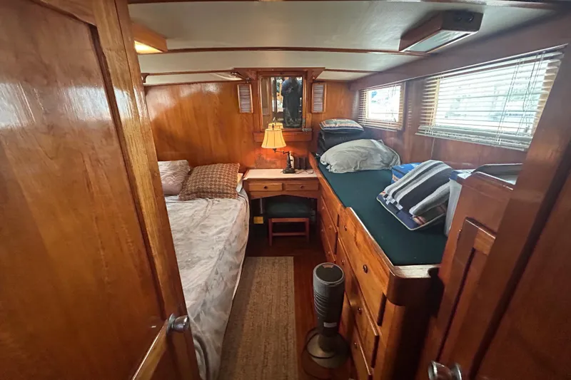 Slide: The Image of Cozy 1976 Bristol Trawler cabin with wooden interior, bed, and desk. - 23