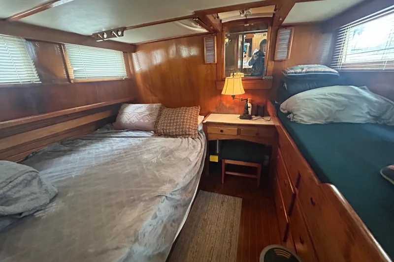 Slide: The Image of Cozy cabin interior of a 1976 Bristol Trawler with wooden furnishings and comfortable bedding. - 25