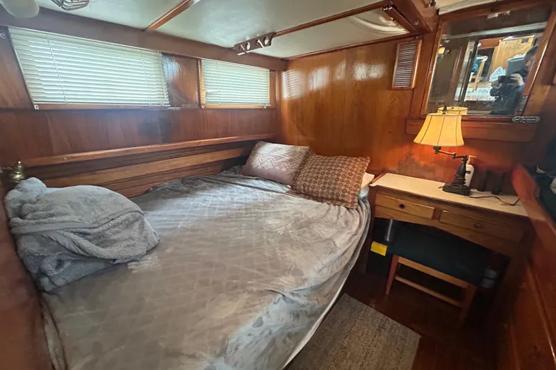 Slide: The Image of Cozy cabin bedroom in a 1976 Bristol Trawler with wooden interior and soft lighting. - 26